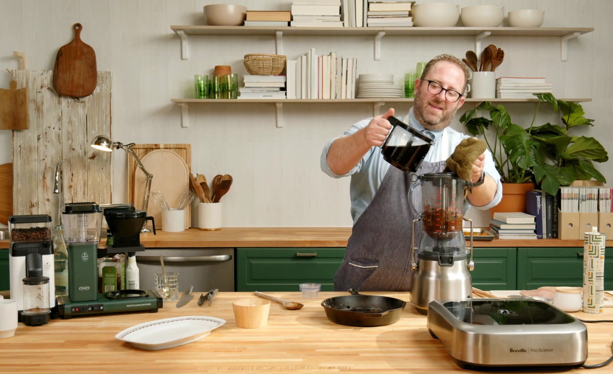 Chef Joel Gamoran stands in the Homemade kitchen, pouring coffee from a KBGV Select carafe into a blender filled with mole.