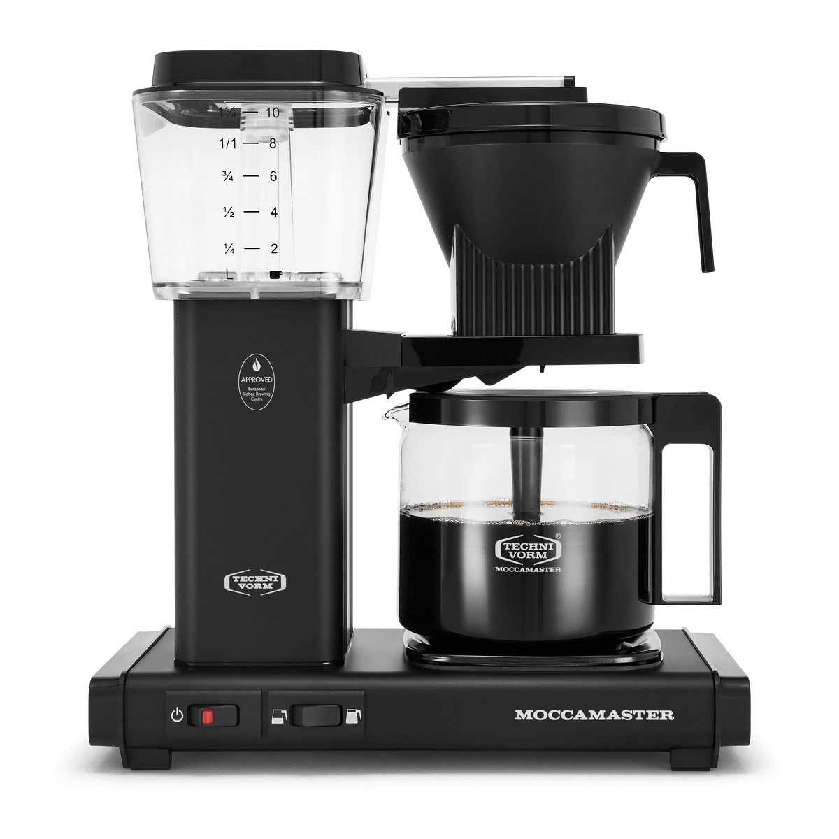 Front shot showing Moccamaster KBGV Select in Matte Black, with rectangular tower and base, clear acrylic water reservoir with fill level marks, power and volume selector switch, glass carafe with black handle, and black automatic brew basket.