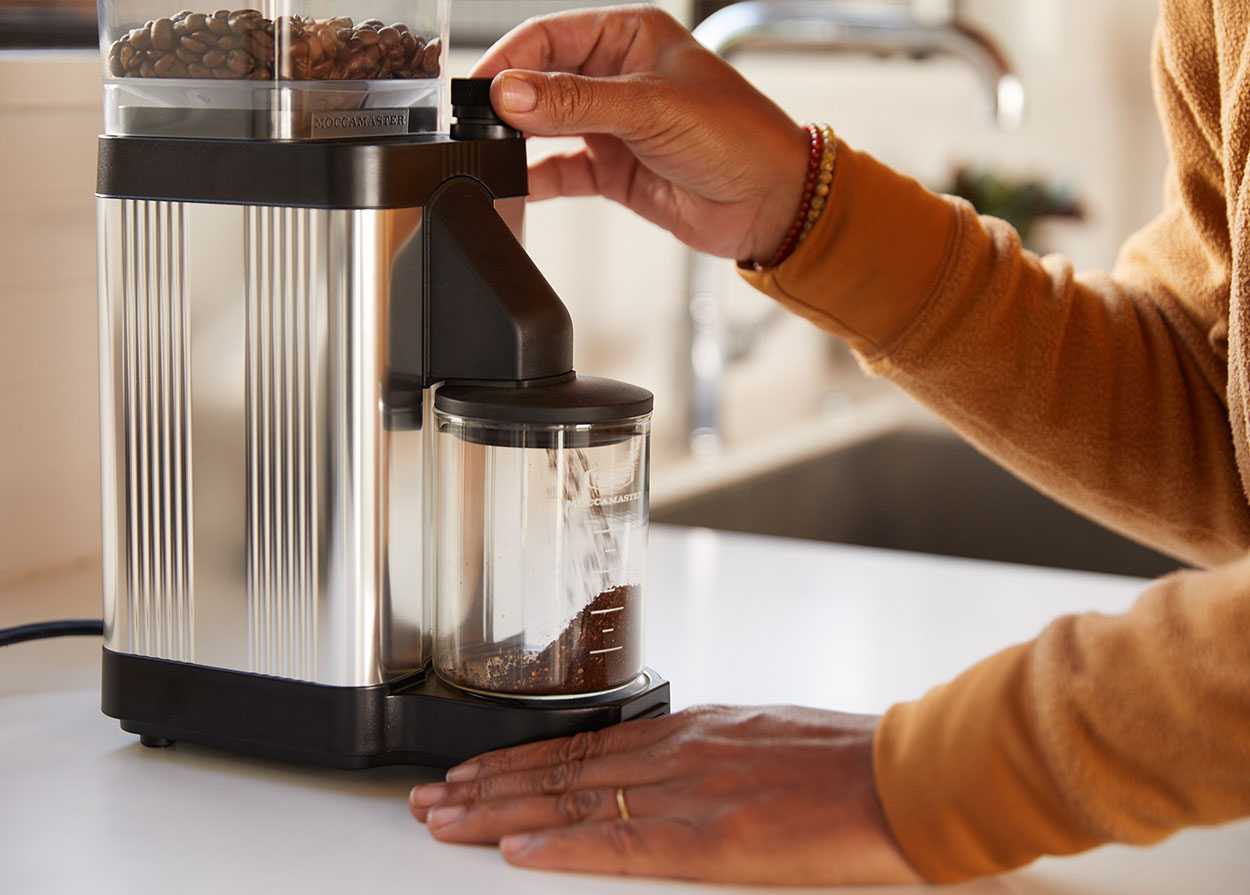 Coffee grinder grinding coffee beans