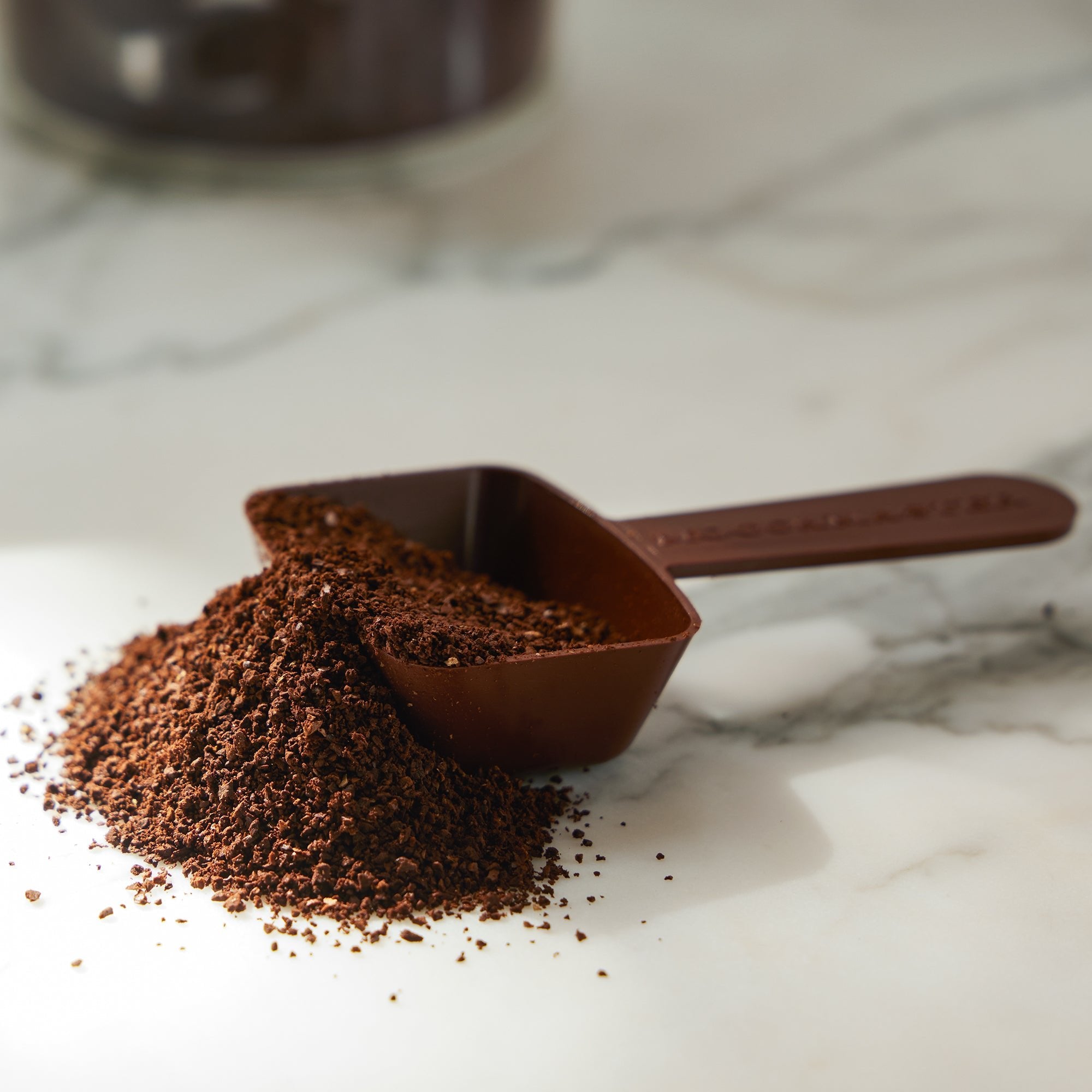 A brown 2-tablespoon coffee ground scoop.