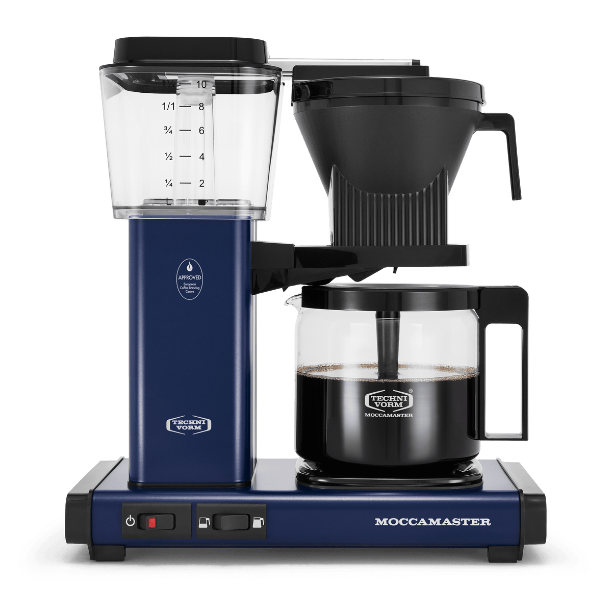 Front shot showing Moccamaster KBGV Select in Midnight Blue, with rectangular tower and base, clear acrylic water reservoir with fill level marks, power and volume selector switch, glass carafe with black handle, and black automatic brew basket. 